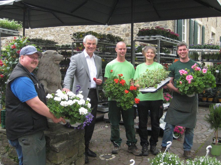 Bürgermeister Klaus Pesch freut sich mit Philipp Hoff, Sven Menten, Ursula Merlo und Mathias Hoff, dass die beliebten Ratinger Blumenampeln ab Mai wieder die historische Innenstadt bereichern.